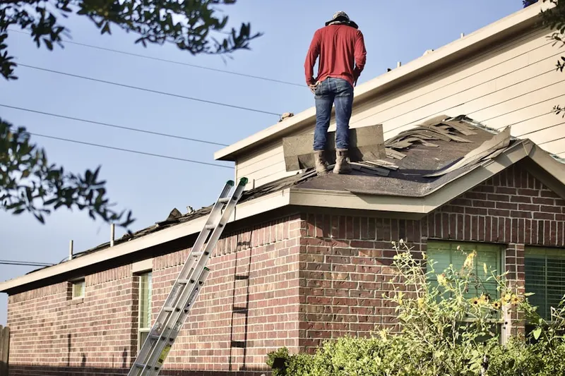 Professional roofer working on a residential roof in Groesbeck